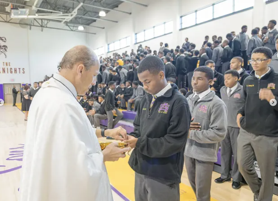 Purple Knights receiving Communion